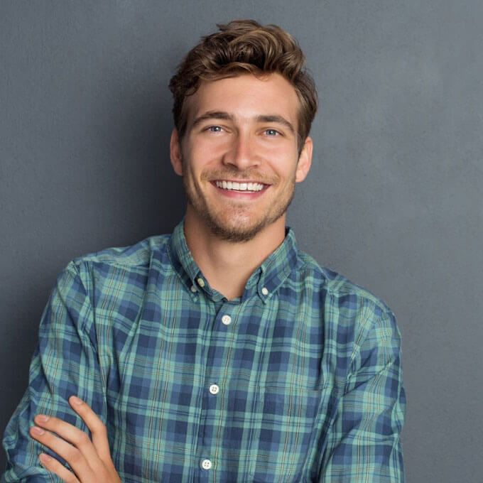 young man in plaid shirt smiling